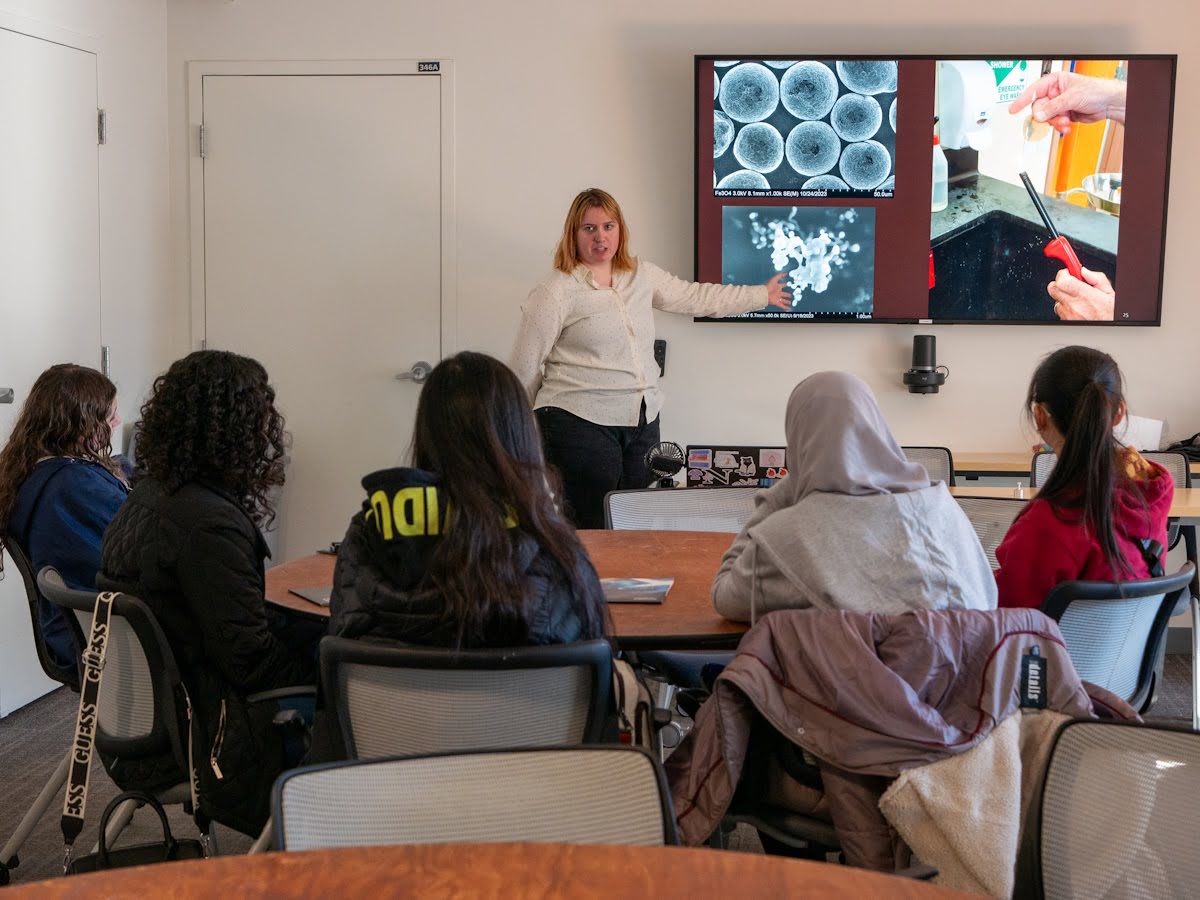 Echo presenting to students with materials research slides