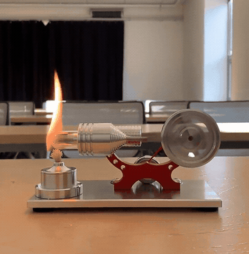 A Stirling engine spinning, powered by an alcohol lamp flame