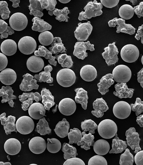 SEM image showing spherical and irregular iron oxide particles