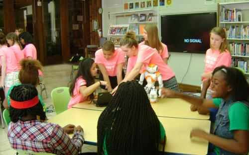 Students working together at workshop tables